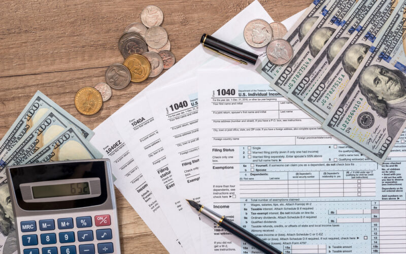 Closeup,Of,Us,Tax,Form,And,Us,Money,With,Calculator,